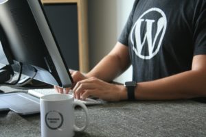 A WordPress developer wearing a WordPress branded t-shirt